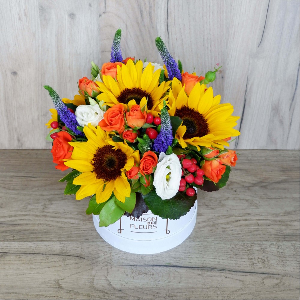 Flower arrangement in a white box with Sunflowers